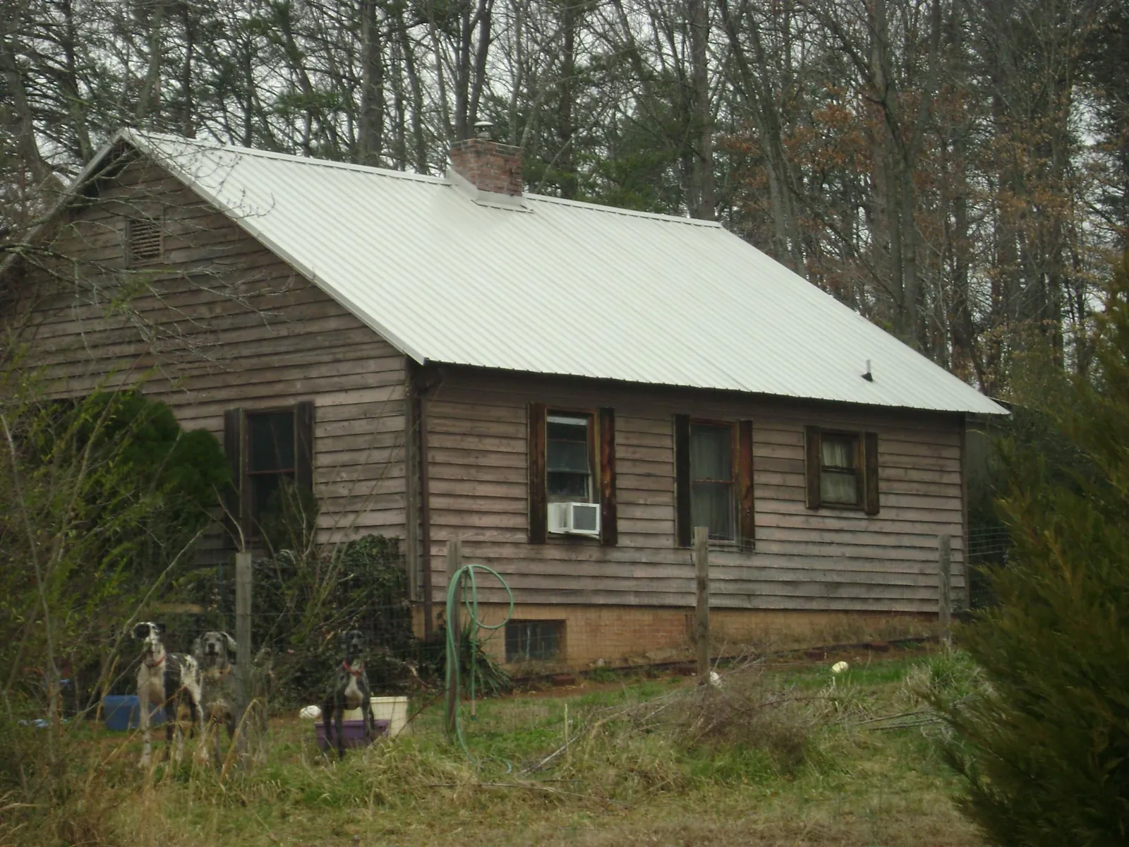 White metal roof on an old wood sided farmhouse, from a Metal Roof Installation job in Schiller Park